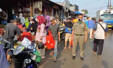 Petugas unit Satpol PP Kecamatan Parung sebagai bagian Satgas Covid 19 mengadakan giat himbauan pelaksanaan protokol kesehatan (prokes) pencegahan corona di Pasar Parung.